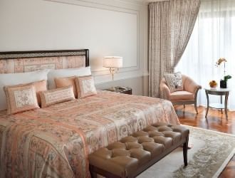 Palazzo Versace Dubai residence interior showing Versace Home Collection furnishings with signature colour palette, stone mosaic tiling, and bespoke Versace fabrics
