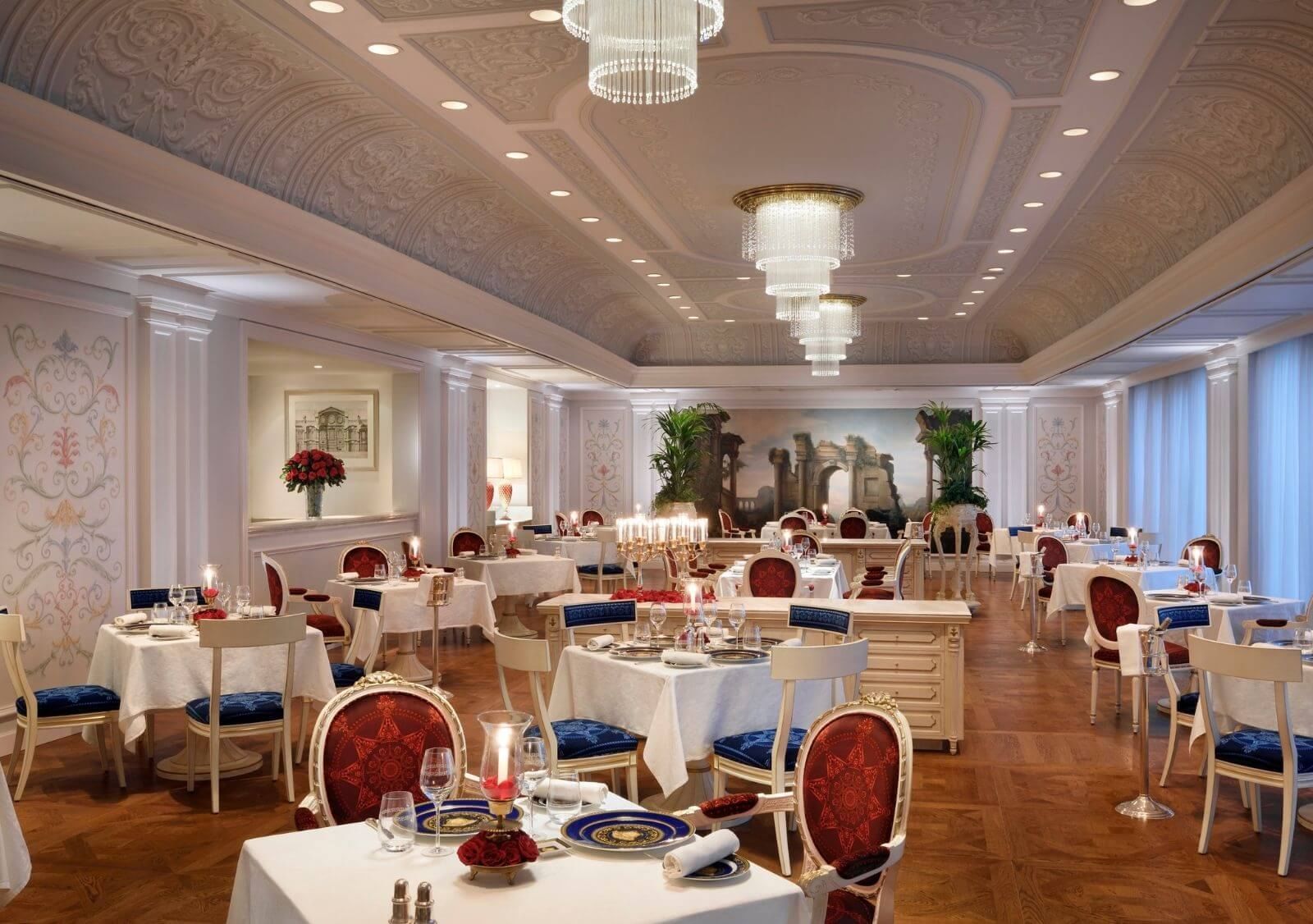 Vanitas restaurant interior at Palazzo Versace Dubai, showing Versace-designed furnishings and the brand's signature Baroque patterns in a fully immersive hospitality setting